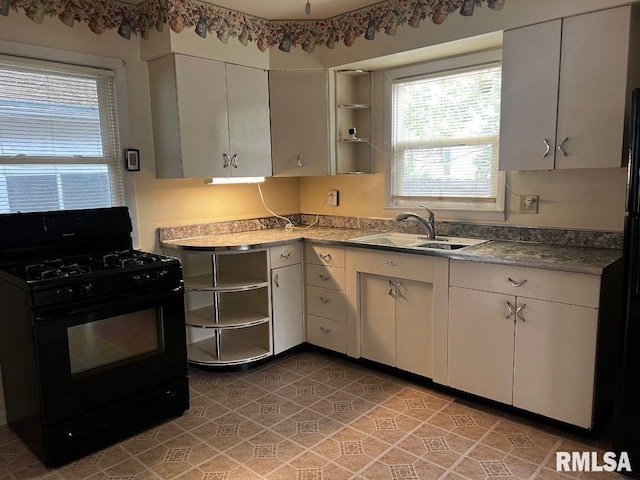 604 Eastman Ave Unit A, Springfield, IL 62702 - kitchen with black range with gas stovetop, open shelves, and plenty of natural light