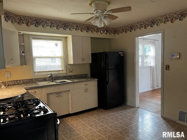 604 Eastman Ave Unit A, Springfield, IL 62702 - kitchen with black appliances, healthy amount of natural light, a ceiling fan, and white cabinetry