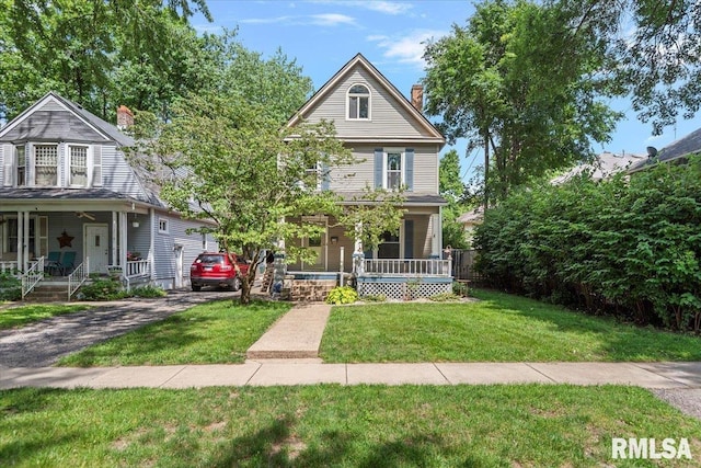 720 S Park Ave, Springfield, IL 62704 - victorian home featuring covered porch, a chimney, and a front yard
