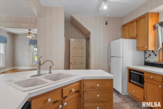 720 S Park Ave, Springfield, IL 62704 - kitchen featuring ceiling fan, stainless steel microwave, freestanding refrigerator, light countertops, and tasteful backsplash