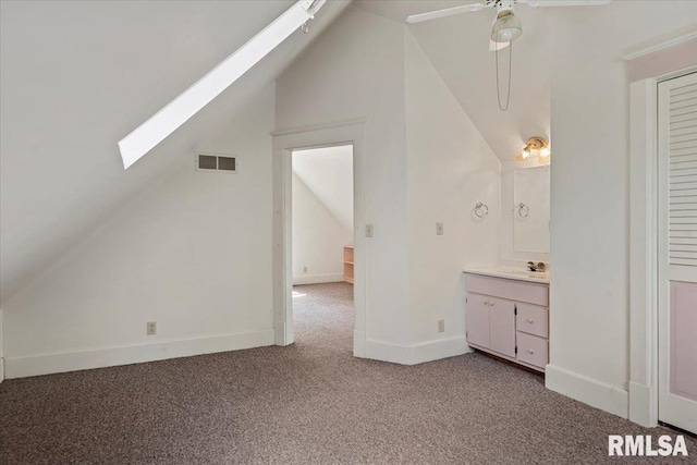 720 S Park Ave, Springfield, IL 62704 - additional living space featuring vaulted ceiling, light colored carpet, a skylight, and ceiling fan
