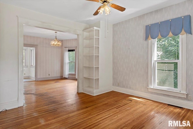 720 S Park Ave, Springfield, IL 62704 - unfurnished room featuring hardwood / wood-style floors, wallpapered walls, plenty of natural light, a chandelier, and ceiling fan
