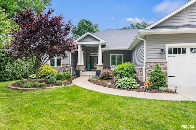 10 The Elms Ln, Springfield, IL 62712 - view of front of property featuring stone siding, a front lawn, a garage, and a shingled roof