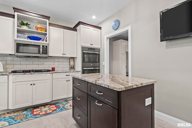10 The Elms Ln, Springfield, IL 62712 - kitchen featuring stainless steel appliances, white cabinets, tasteful backsplash, light stone countertops, and open shelves