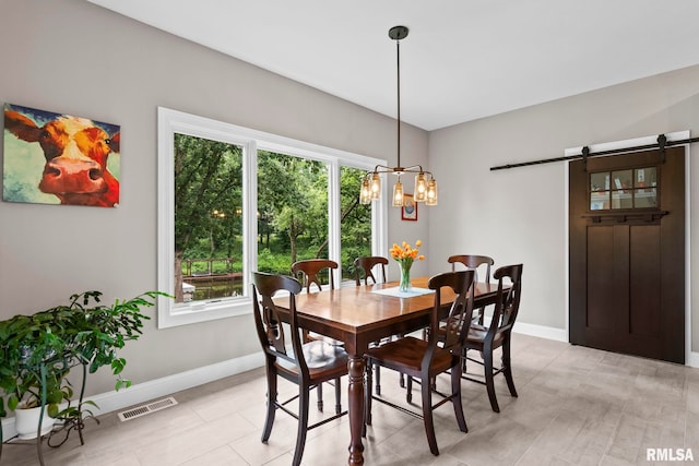 10 The Elms Ln, Springfield, IL 62712 - dining area featuring a barn door, healthy amount of natural light, and a chandelier