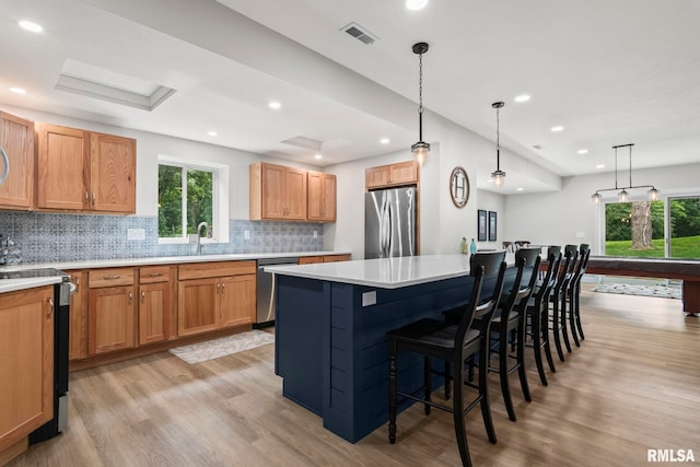10 The Elms Ln, Springfield, IL 62712 - kitchen with stainless steel appliances, light wood-type flooring, a kitchen island, a kitchen bar, and recessed lighting