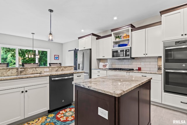 10 The Elms Ln, Springfield, IL 62712 - kitchen with appliances with stainless steel finishes, decorative backsplash, hanging light fixtures, recessed lighting, and white cabinets