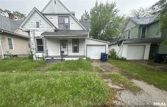 518 E 4th Ave, Monmouth, IL 61462 - traditional-style house with a porch, a garage, and driveway