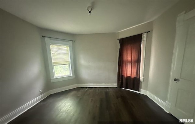 518 E 4th Ave, Monmouth, IL 61462 - spare room with dark wood-type flooring and baseboards