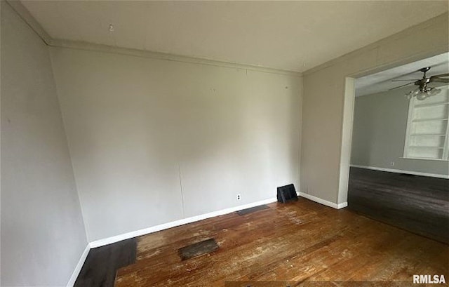 518 E 4th Ave, Monmouth, IL 61462 - empty room with dark wood-type flooring, ceiling fan, and ornamental molding