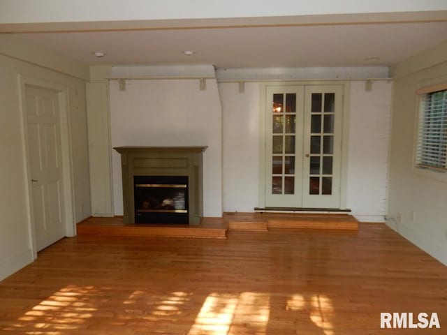 635 S Seigel St, Decatur, IL 62522 - unfurnished living room featuring wood finished floors, a fireplace, and french doors