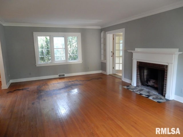635 S Seigel St, Decatur, IL 62522 - unfurnished living room featuring a brick fireplace, crown molding, and wood finished floors