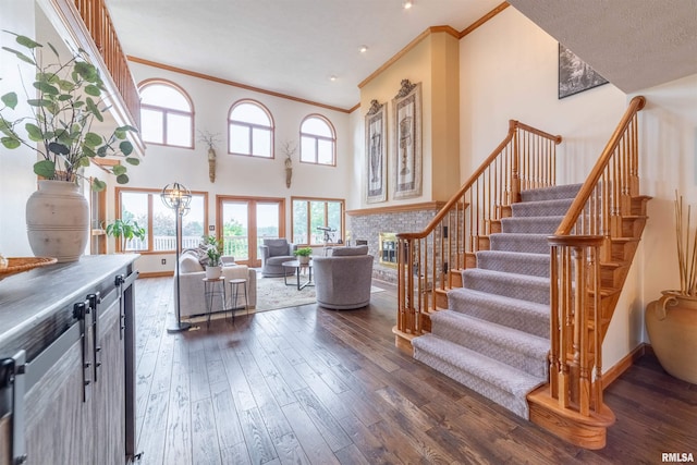 3939 Musholt Strasse Ln, Quincy, IL 62305 - stairs with ornamental molding, hardwood / wood-style floors, and a high ceiling