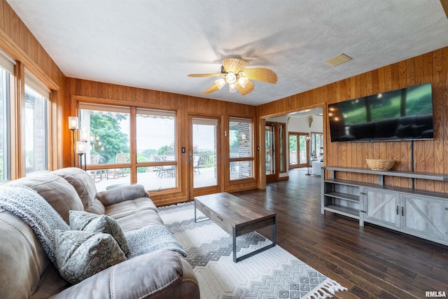 3939 Musholt Strasse Ln, Quincy, IL 62305 - living room with wooden walls, plenty of natural light, a ceiling fan, dark wood-style flooring, and a textured ceiling