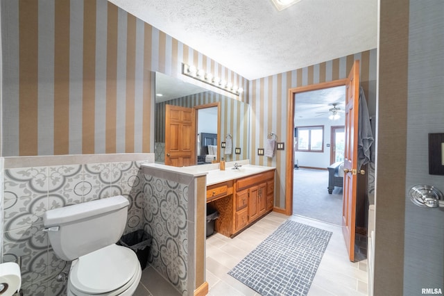 3939 Musholt Strasse Ln, Quincy, IL 62305 - bathroom with wallpapered walls, vanity, and a ceiling fan