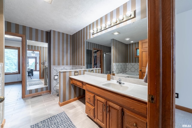 3939 Musholt Strasse Ln, Quincy, IL 62305 - full bath featuring wallpapered walls, a textured ceiling, vanity, and a tub