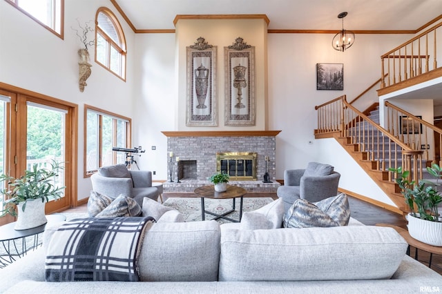 3939 Musholt Strasse Ln, Quincy, IL 62305 - living area featuring a towering ceiling, healthy amount of natural light, stairs, a brick fireplace, and ornamental molding