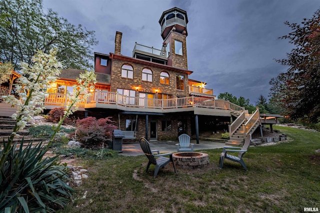 3939 Musholt Strasse Ln, Quincy, IL 62305 - rear view of property featuring an outdoor fire pit, a patio area, stairs, a lawn, and a wooden deck
