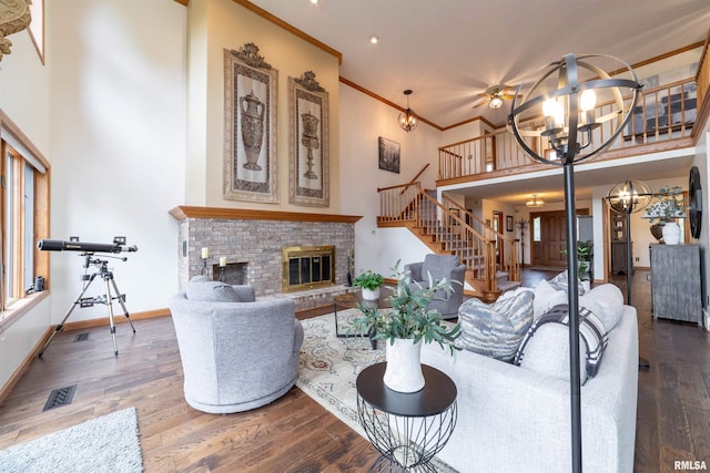 3939 Musholt Strasse Ln, Quincy, IL 62305 - living area with a high ceiling, stairs, wood finished floors, a brick fireplace, and ornamental molding