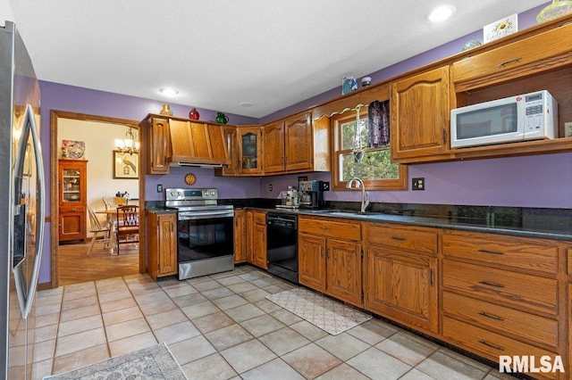 3713 Tyler Ct, Springfield, IL 62711 - kitchen featuring stainless steel appliances, brown cabinetry, dark countertops, and a chandelier