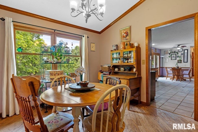 3713 Tyler Ct, Springfield, IL 62711 - dining area featuring lofted ceiling, a chandelier, crown molding, a ceiling fan, and light wood-style flooring