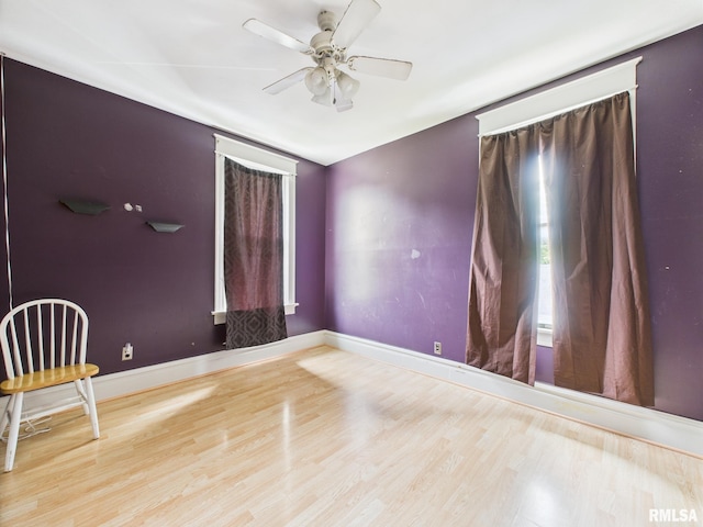 222 N Lewis St, Blue Mound, IL 62513 - empty room with wood finished floors, a ceiling fan, and plenty of natural light