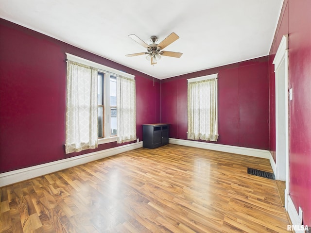 222 N Lewis St, Blue Mound, IL 62513 - empty room featuring ceiling fan, healthy amount of natural light, and wood finished floors