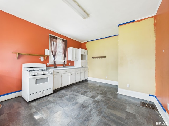 222 N Lewis St, Blue Mound, IL 62513 - kitchen with white gas range oven, white cabinets, light countertops, and ornamental molding