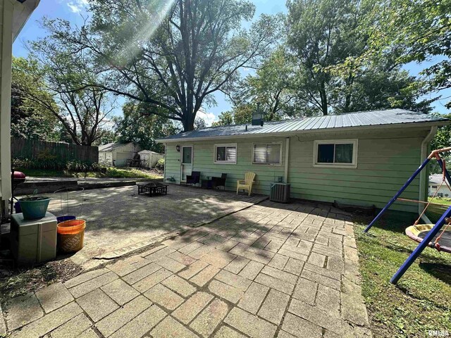 1025 S 15th St, Quincy, IL 62301 - back of property featuring a fire pit, a patio, and a metal roof