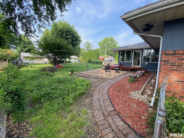 27 Apache Dr, Springfield, IL 62711 - view of grassy yard with a sunroom and a patio area