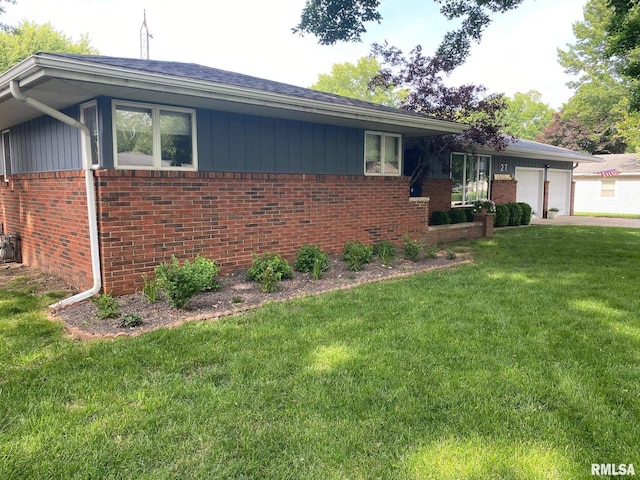 27 Apache Dr, Springfield, IL 62711 - view of side of property featuring brick siding, a yard, an attached garage, driveway, and roof with shingles