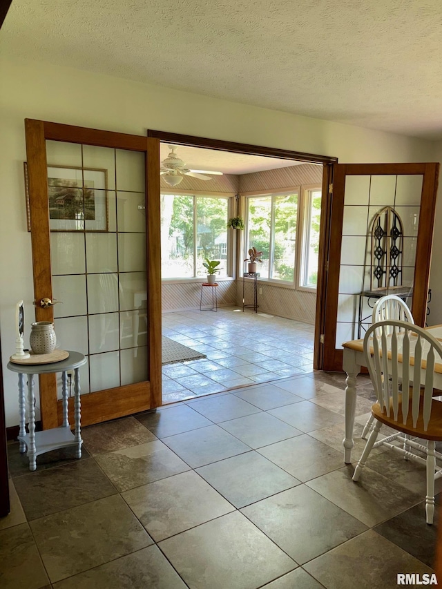 27 Apache Dr, Springfield, IL 62711 - doorway to outside featuring a textured ceiling, tile patterned flooring, and ceiling fan
