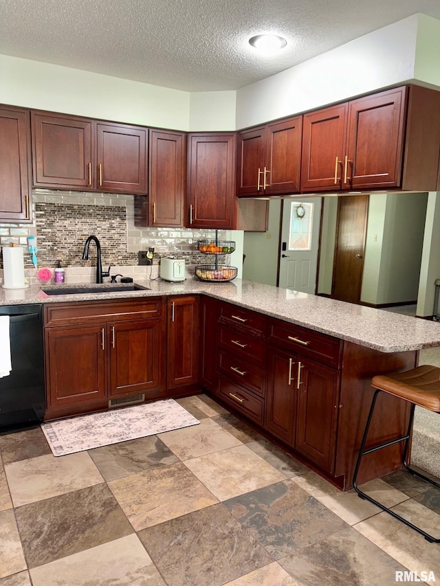27 Apache Dr, Springfield, IL 62711 - kitchen featuring black dishwasher, a peninsula, a textured ceiling, tasteful backsplash, and light stone counters