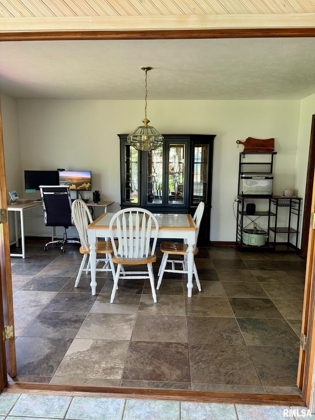 27 Apache Dr, Springfield, IL 62711 - dining area with a chandelier, dark stone finish flooring, and beamed ceiling
