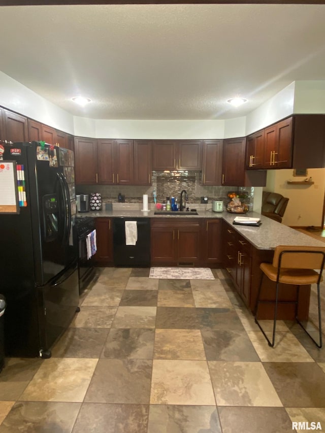 27 Apache Dr, Springfield, IL 62711 - kitchen featuring black appliances, a peninsula, tasteful backsplash, light countertops, and dark brown cabinets