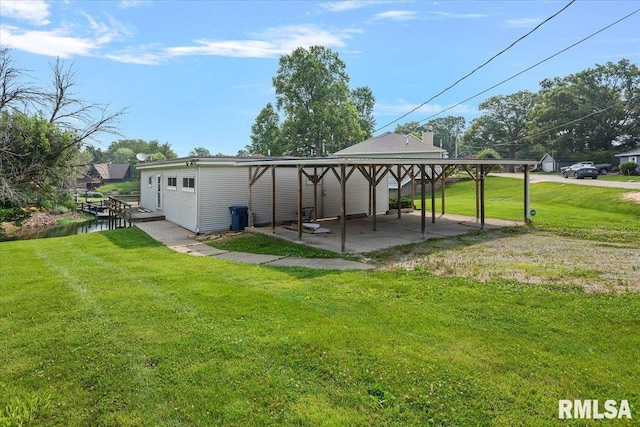 308 Elm Ln, Petersburg, IL 62675 - exterior space with a patio area, a yard, and a carport