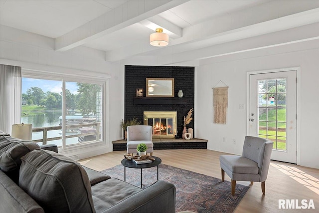 308 Elm Ln, Petersburg, IL 62675 - living area with beamed ceiling, wood finished floors, a brick fireplace, and a water view