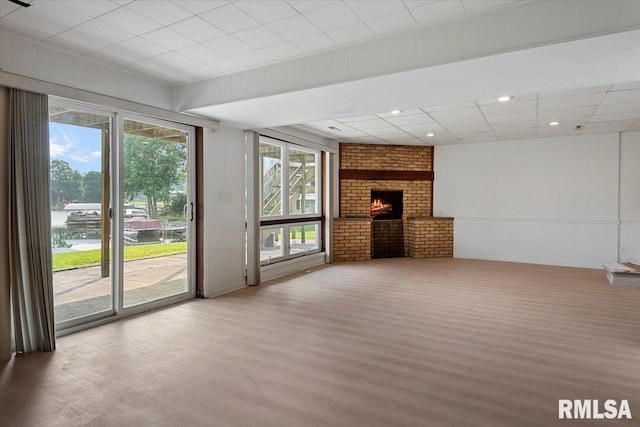308 Elm Ln, Petersburg, IL 62675 - unfurnished living room with wood finished floors, recessed lighting, healthy amount of natural light, and a brick fireplace