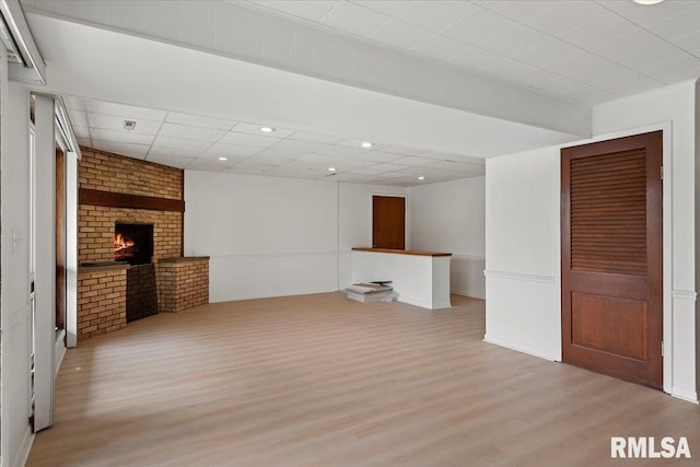 308 Elm Ln, Petersburg, IL 62675 - unfurnished living room featuring light wood finished floors, a brick fireplace, and recessed lighting