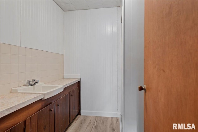 308 Elm Ln, Petersburg, IL 62675 - bathroom featuring decorative backsplash, wood finished floors, and vanity