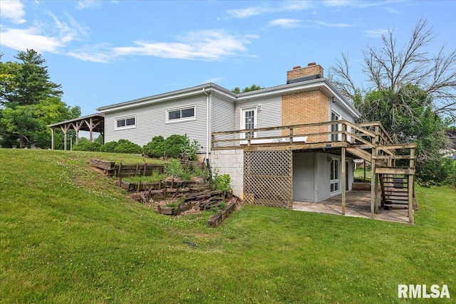308 Elm Ln, Petersburg, IL 62675 - rear view of property with a vegetable garden, a chimney, stairway, a wooden deck, and a lawn