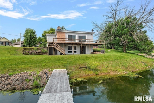 308 Elm Ln, Petersburg, IL 62675 - rear view of property featuring a deck with water view, stairs, a yard, and a chimney