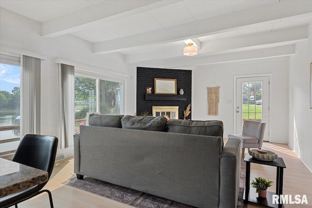308 Elm Ln, Petersburg, IL 62675 - living area with plenty of natural light, wood finished floors, beam ceiling, and a brick fireplace
