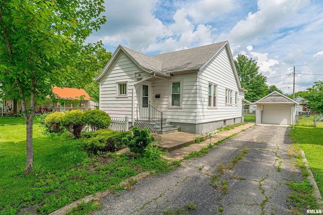 712 N Kickapoo St, Lincoln, IL 62656 - view of front of property with a detached garage, an outdoor structure, and roof with shingles