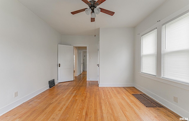 712 N Kickapoo St, Lincoln, IL 62656 - unfurnished room with a ceiling fan and light wood-type flooring