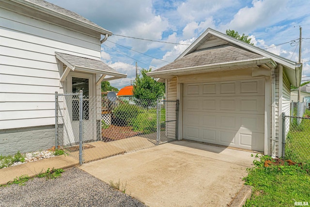 712 N Kickapoo St, Lincoln, IL 62656 - detached garage featuring concrete driveway and a gate