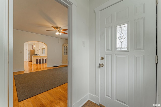 712 N Kickapoo St, Lincoln, IL 62656 - entryway with arched walkways, ceiling fan, and light wood-type flooring