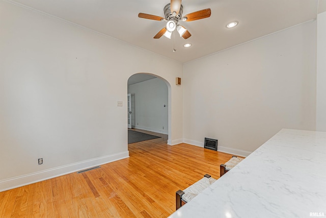 712 N Kickapoo St, Lincoln, IL 62656 - bedroom with arched walkways, recessed lighting, light wood finished floors, and ceiling fan