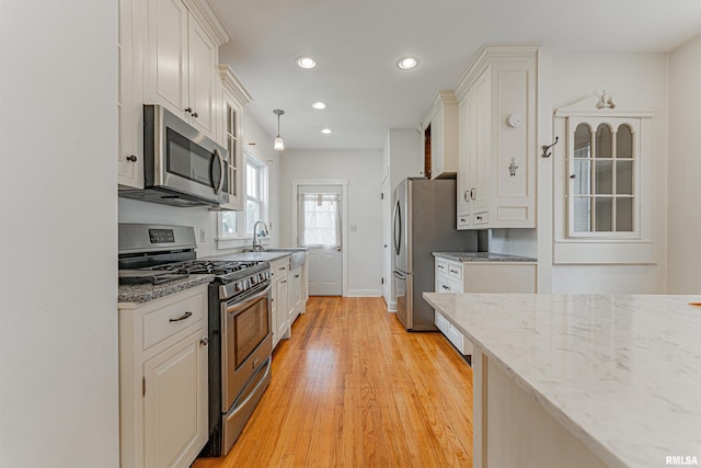712 N Kickapoo St, Lincoln, IL 62656 - kitchen with stainless steel appliances, light wood-type flooring, white cabinets, recessed lighting, and light stone countertops