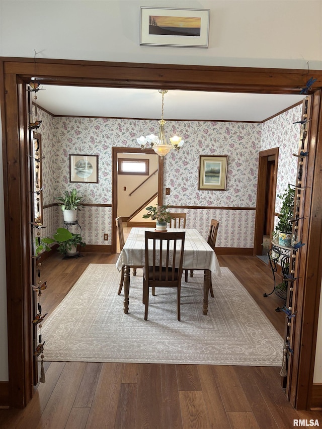 1905 S Whittier Ave, Springfield, IL 62704 - dining space featuring wallpapered walls, wood finished floors, and a chandelier